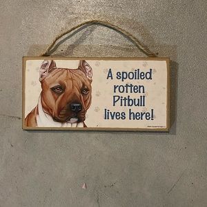 A spoiled, rotten pitbull lives here sign